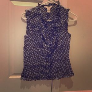 Polka dot sleeveless blouse.